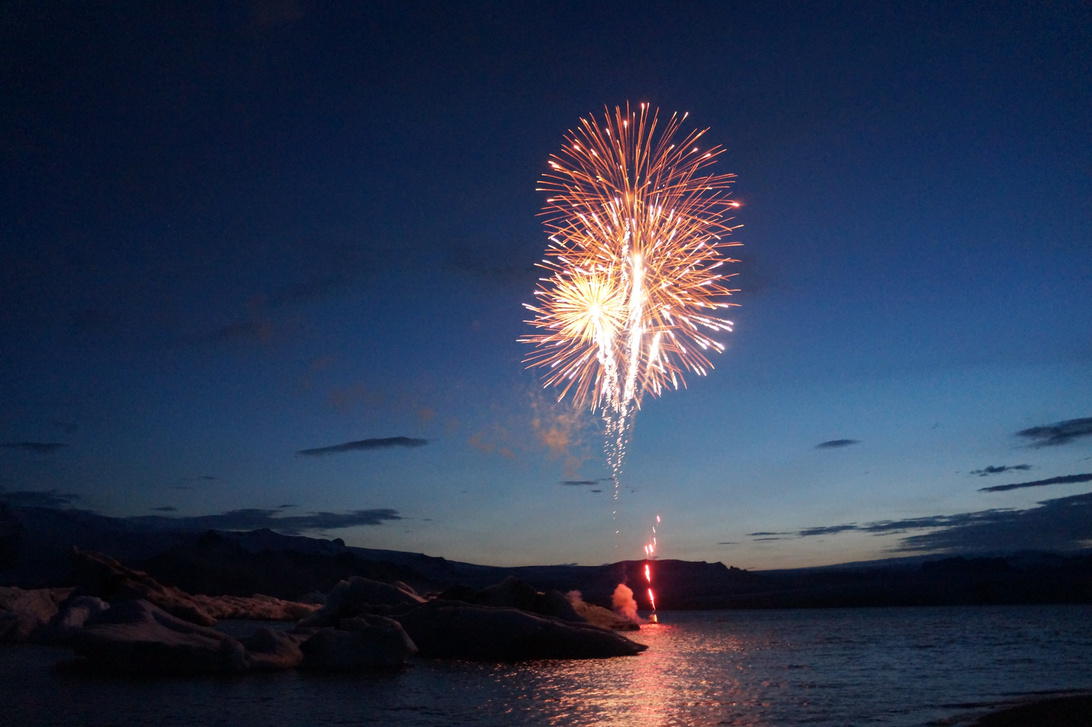 Fireworks Display over the Sea during Night Time